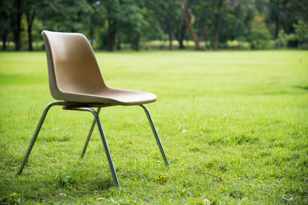 plastic chair stainless support  on green lawnの写真素材