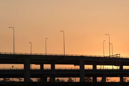 Silhouette photo of toll way in morningh sunriseの写真素材