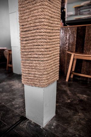 Braided rope wrapped around a concrete post in interior room decoration