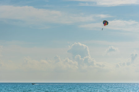 traveller parasailing with speed boat over the sea