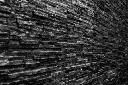 Wet black slate stone from water feature wall  texture backgroundの写真素材