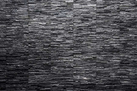 Wet black slate stone from water feature wall  texture backgroundの写真素材