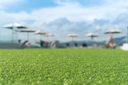focus on front of artificial grass floor  with  sunbed blurred backgroundの写真素材