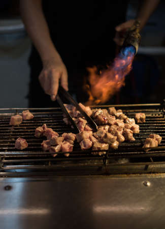 asian style barbecue cooking with flame torch burner , very delicious street foodの写真素材