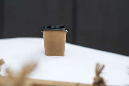 blank take away coffee paper cup put on snow in winter seasonの写真素材