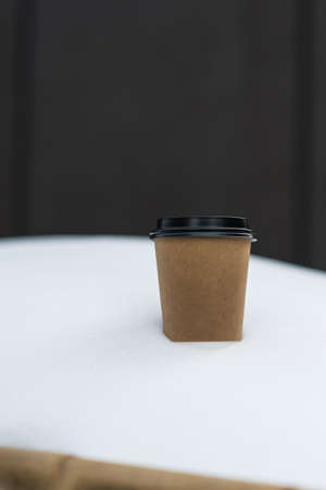 blank take away coffee paper cup put on snow in winter seasonの写真素材