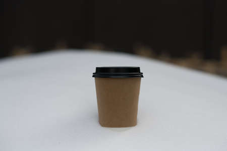 blank take away coffee paper cup put on snow in winter seasonの写真素材