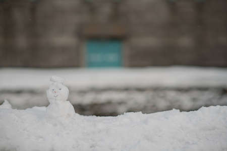kid play sculpt snow of very cute snow man  in winter seasonの写真素材