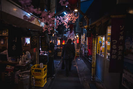 Tokyo, Japan - April 3 , 2018 : Famous place Japanese local steet food at Omoide Yokocho, Shinjuku tokyo in spring season , decorated with sakura cherry blossom very beautiful sceneのeditorial素材