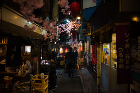 Tokyo, Japan - April 3 , 2018 : Famous place Japanese local steet food at Omoide Yokocho, Shinjuku tokyo in spring season , decorated with sakura cherry blossom very beautiful sceneのeditorial素材