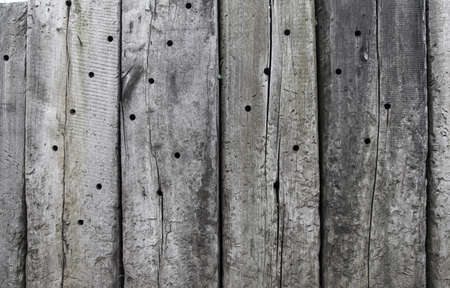 weathered beautiful pattern log wood plank wall texture with holeの写真素材