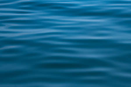 abstract motion wave water in ocean with sunlight backgroundの写真素材