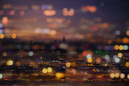 abstract blurred bokeh background from city downtown lighting with defocused and double explosure...
