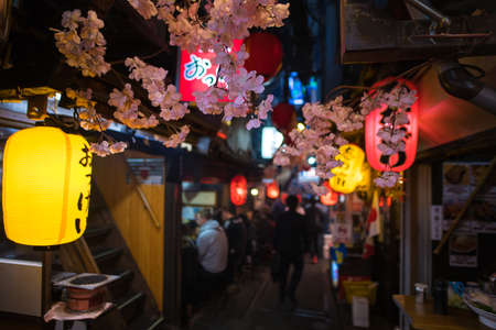 Tokyo, Japan - April 3 , 2018 : Famous place Japanese local street food at Omoide Yokocho, Shinjuku tokyo in spring season, decorated with sakura cherry blossom very beautiful sceneのeditorial素材