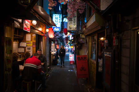Tokyo, Japan - April 3 , 2018 : Famous place Japanese local street food at Omoide Yokocho, Shinjuku tokyo in spring season, decorated with sakura cherry blossom very beautiful sceneのeditorial素材