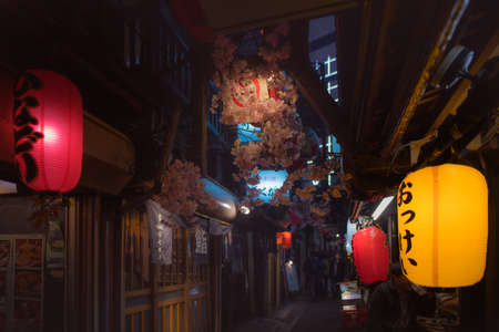 Tokyo, Japan - April 3 , 2018 : Famous place Japanese local street food at Omoide Yokocho, Shinjuku tokyo in spring season, decorated with sakura cherry blossom very beautiful sceneのeditorial素材