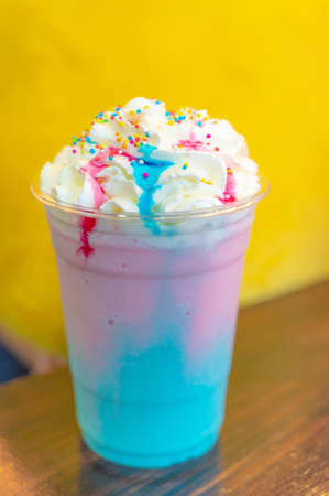 cold lollipop  milkshake drink with whip cream and colorful sugar ballsの写真素材