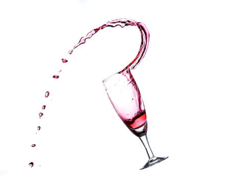 The glass is splashing out of the red waterの写真素材
