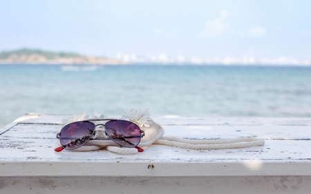 Net flower bag on the table near the seaの写真素材