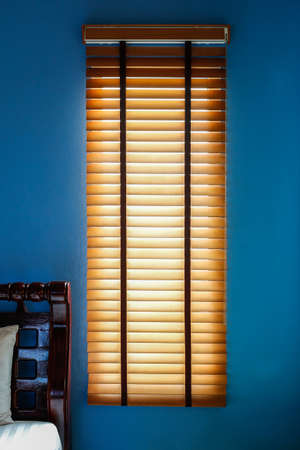 The wood curtain on the blue wall in the morningの写真素材