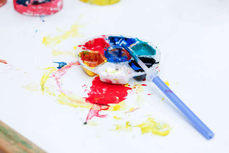 Watercolor and paintbrush on the tableの写真素材