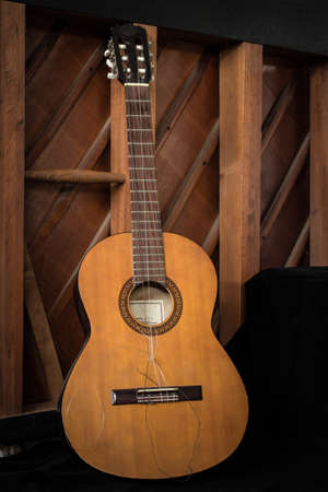 The old guitar put on the floor in low key photoの写真素材
