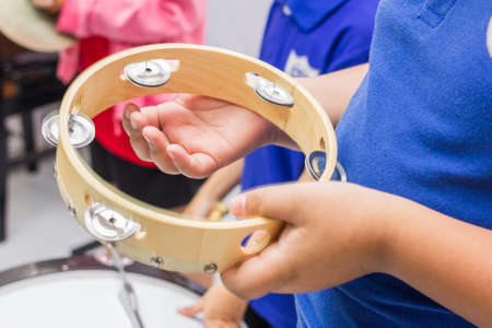 The children is playing tambourineの写真素材