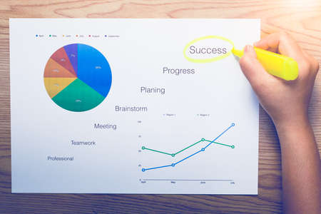 Hand highlighting at business document on the tableの写真素材