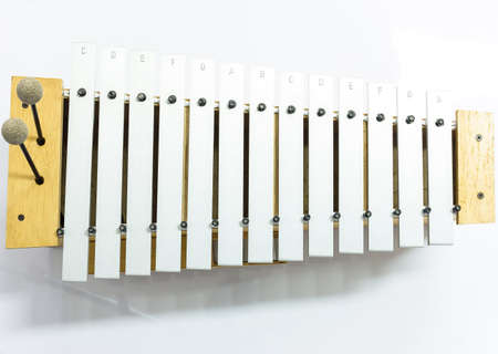 The metallophone and two mallets on the white backgroundの写真素材