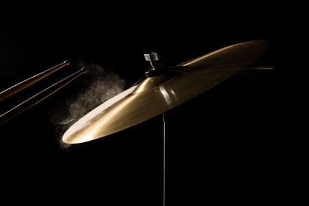 The drum stick hit on the crash in the  low key backgroudの写真素材