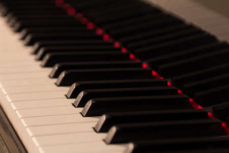 Piano background with selective focus. Warm color toned imageの写真素材