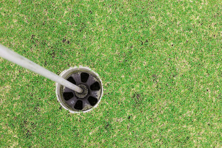 Hole on the green of a golf course, top viewの写真素材