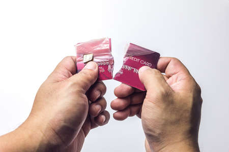 Closeup  hand broke the red credit card on the white background.の写真素材