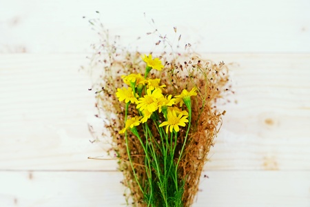 Bouquet of Yellow Daisies on the Table woodの写真素材