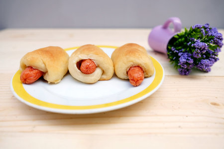 Sausage Bread in Dish on Table Woodの写真素材