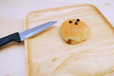 Bread filled with White Chocolate in dish Wood and Knife