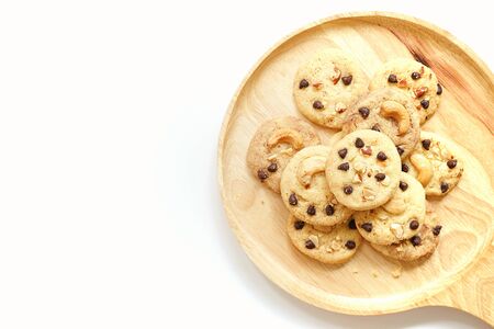 cookies on wooden plate with white backgroundの写真素材