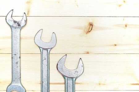set of wrenches on wooden background with copy space. repairs, renovation, overhaul, rehabilitation, refitの写真素材