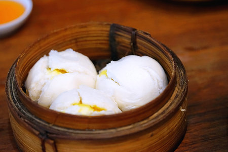 Chinese cuisine, hot and steamy dim sim or steamed Chinese dumplings were set in steamer basket....