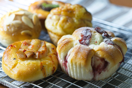 close up Freshly Baked danish pastry on wooden background, assorted bread and pastry, Different kinds of bread rolls. Kitchen or bakery poster designの写真素材