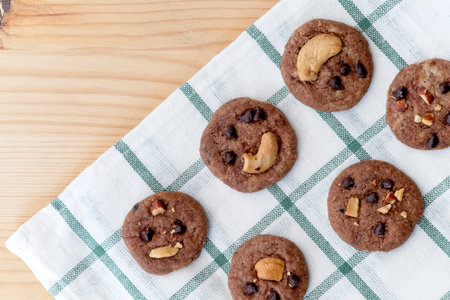 Delicious Chocolate Chip Cookies on checkered tablecloth, Tasty Homemade cookies on wooden table, dessert with . Top view and copy spaceの写真素材