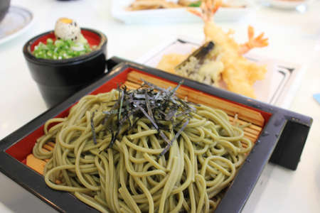 Japanese dry noodle with soup and fried shrimp and vegetableの写真素材