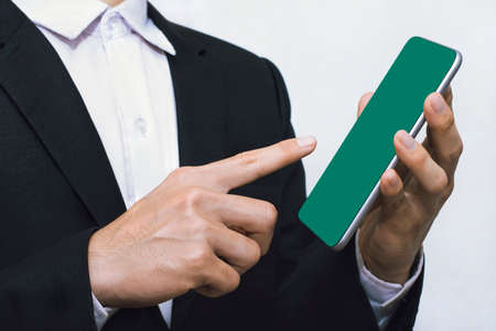 Businessmen controlling mobile applications on a white background, green screen mockup templateの写真素材