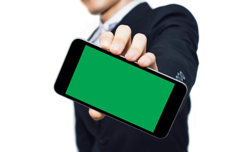 Green screen smartphones are mock up template, to be used for your best content,Business man suit,on...