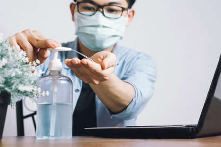 New normal. Asian men wear a mask and wash with alcohol gel, cleansing gel to prevent the spread of germs and bacteria and avoid coronavirus infection (covid 19) Concept home saves lives.の写真素材