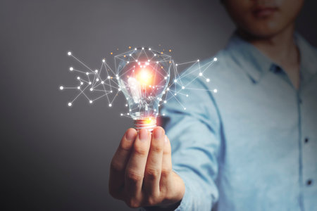 Asian Men holding light bulbs, ideas of new ideas with Innovative technology, Energy saving and...