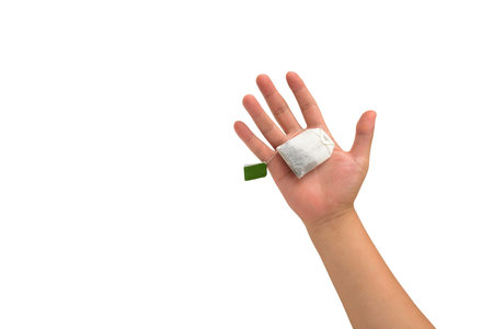 isolated hand holding Teabag