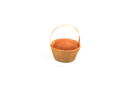 isolated eggs put in a bamboo basketの写真素材