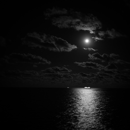 Cruise ship in the moonlight at open seaの写真素材
