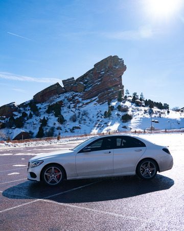 beautiful car in front of mountain with snow during winterの写真素材